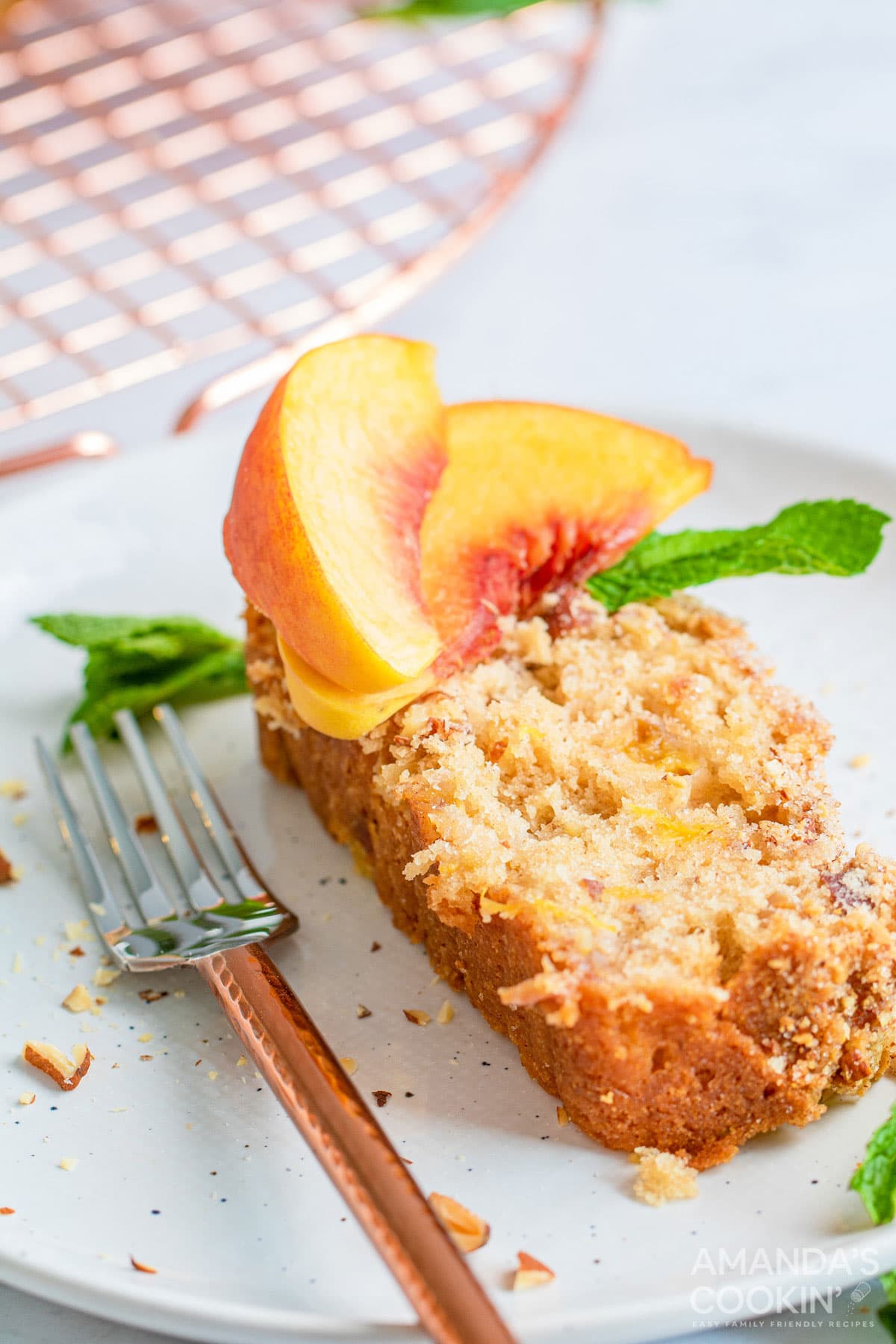slice of peach bread on a plate with a fork