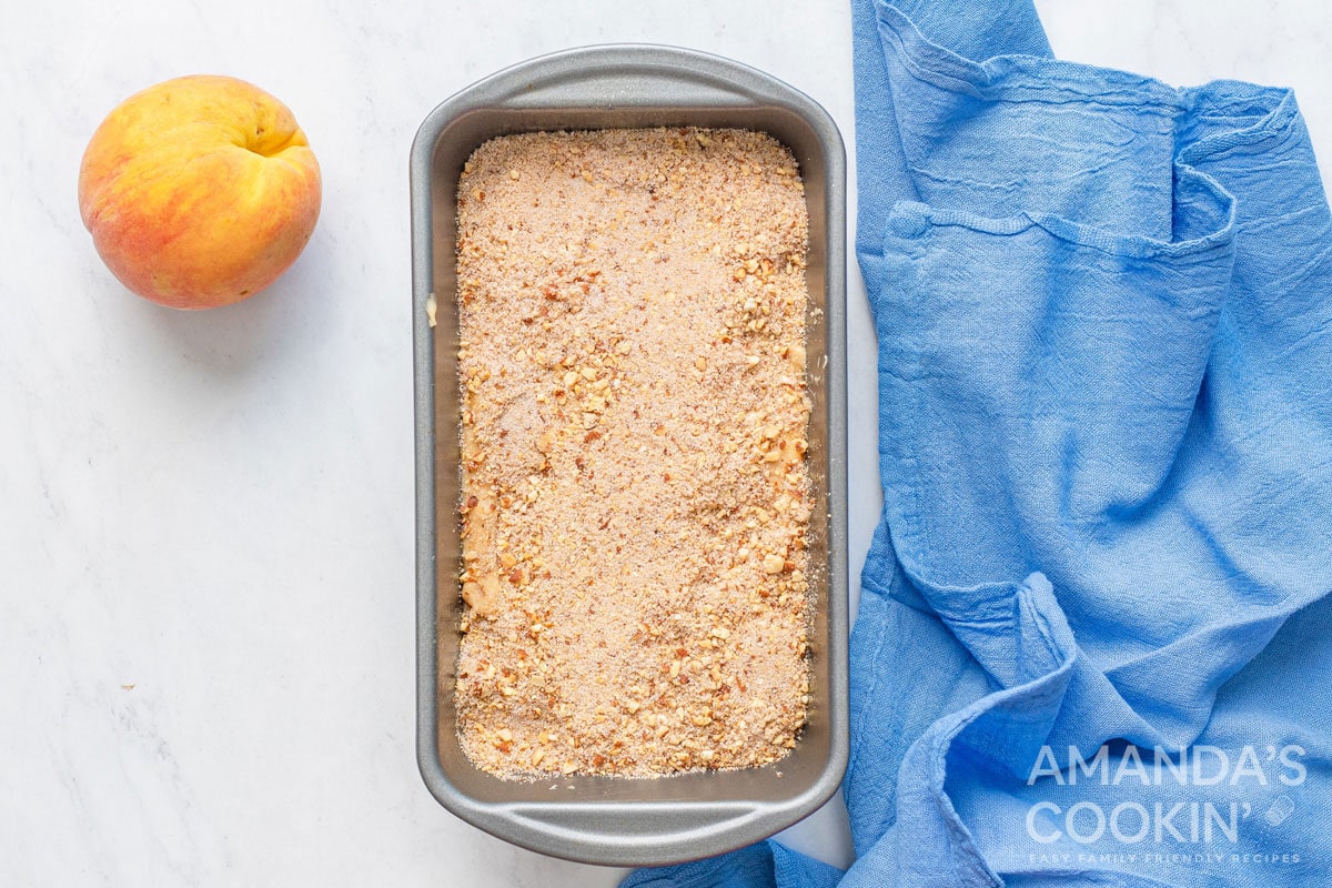 peach bread batter with topping in pan