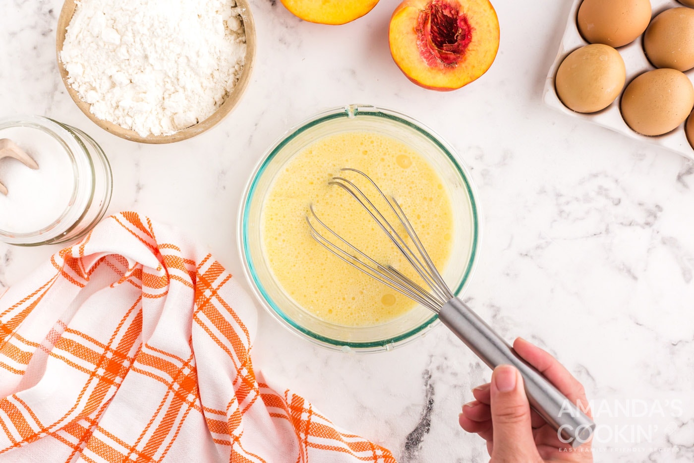 whisking milk, eggs, oil, vanilla, and almond extracts