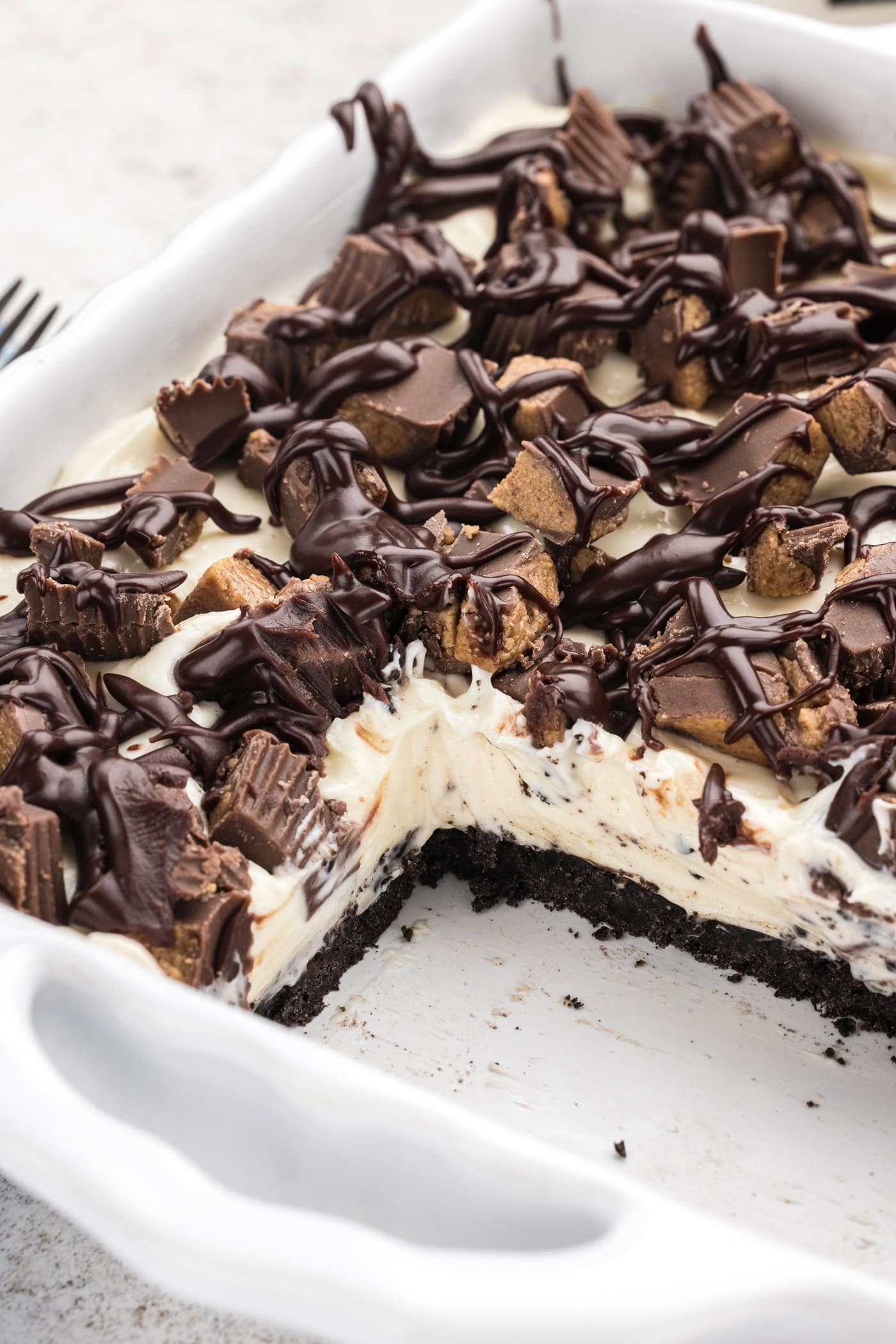 Peanut Butter Oreo No Bake Cheesecake with slices removed