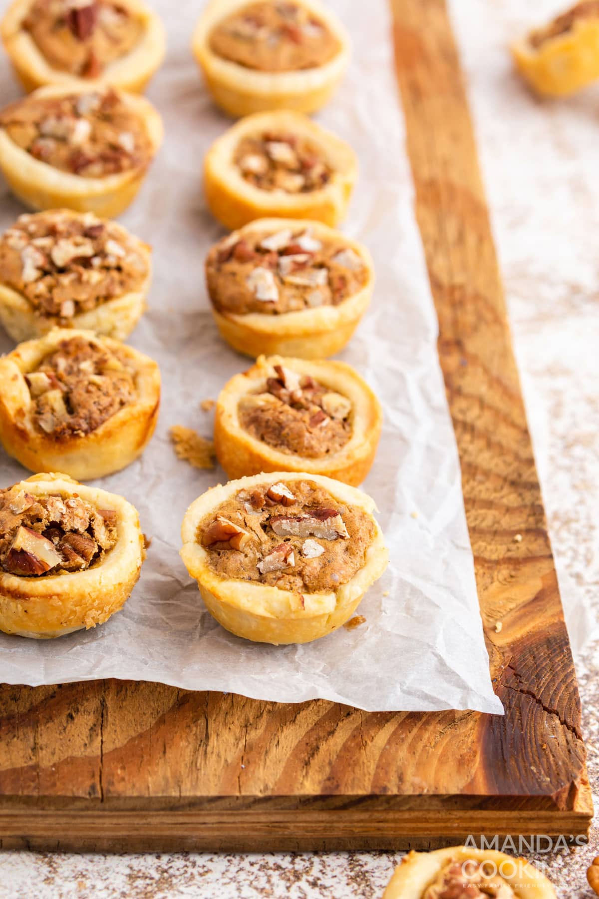 pecan tassies on a wood cutting board