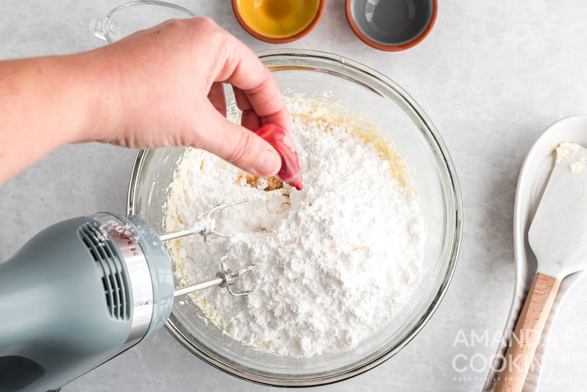 adding food coloring to frosting