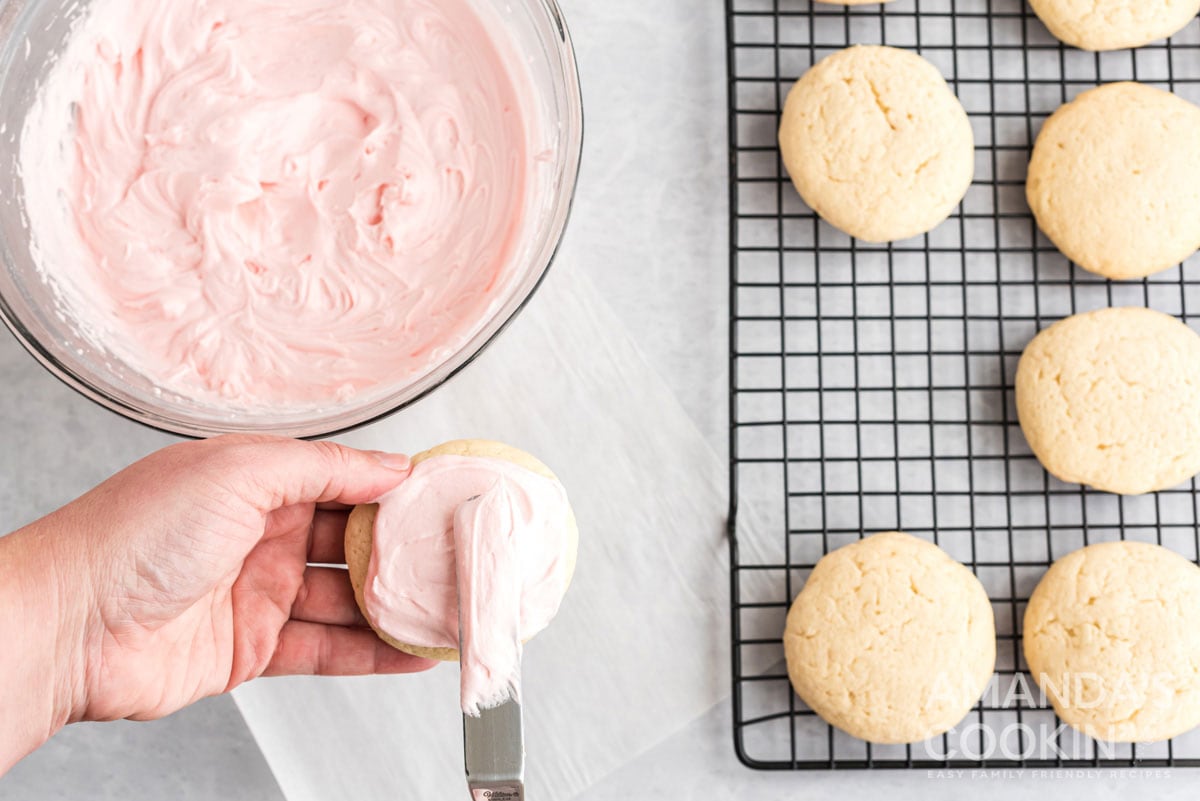 spreading frosting on cookie