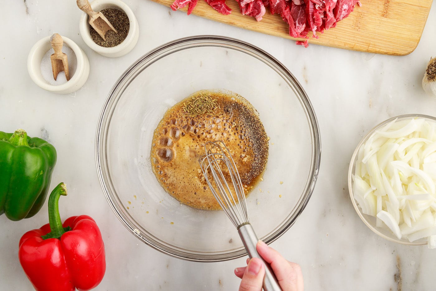 whisking marinade ingredients in a bowl