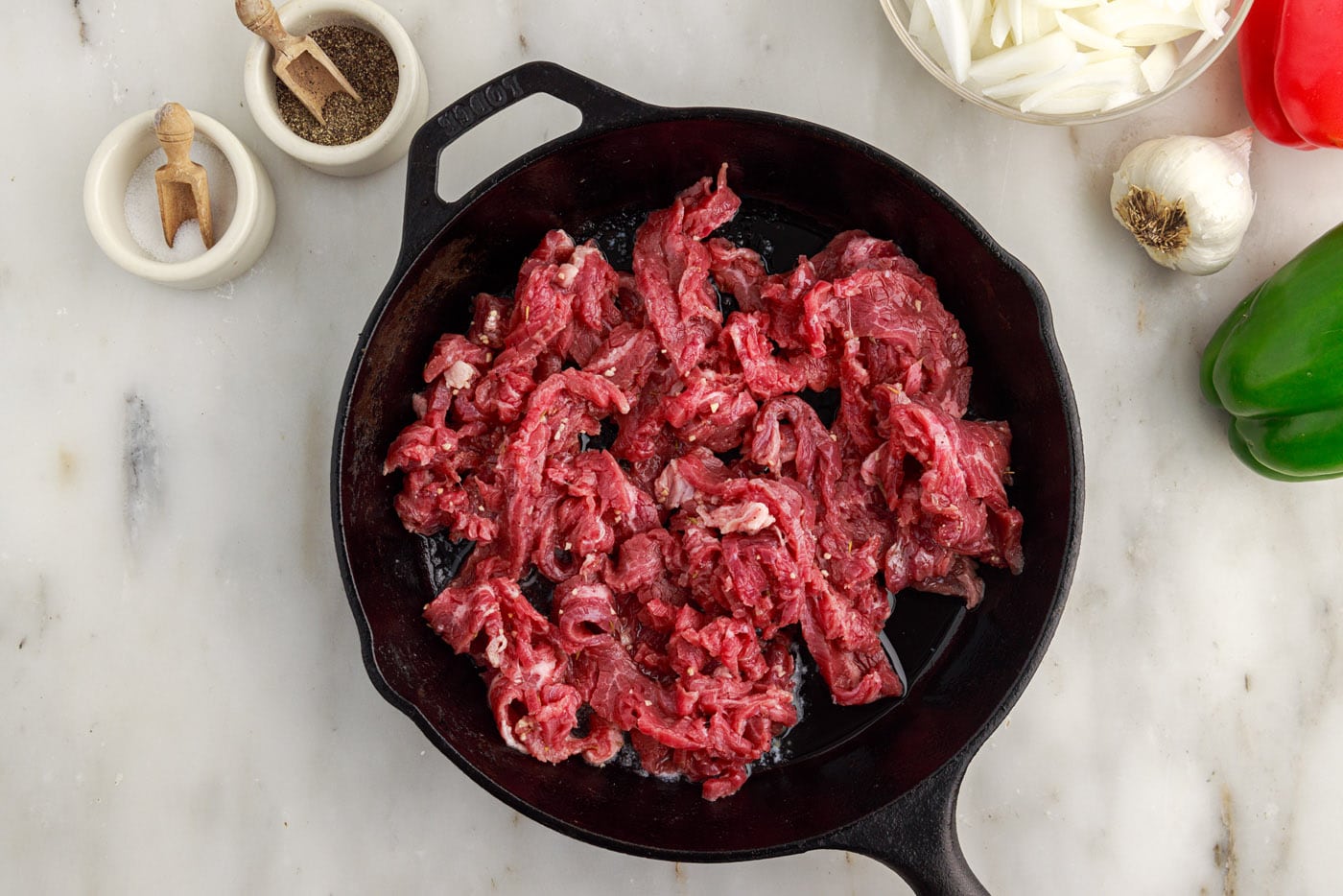 searing flank steak slices in a skllet