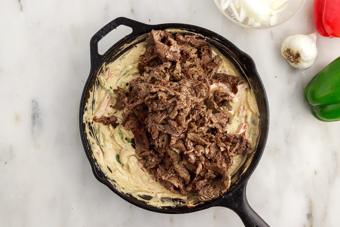 sliced flank steak added on top of cream cheese and veggie mixture