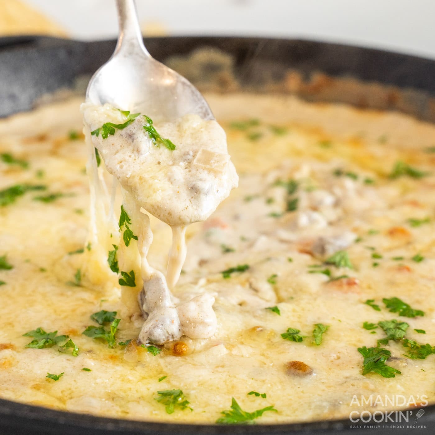 lifting Philly Cheesesteak Dip with a spoon