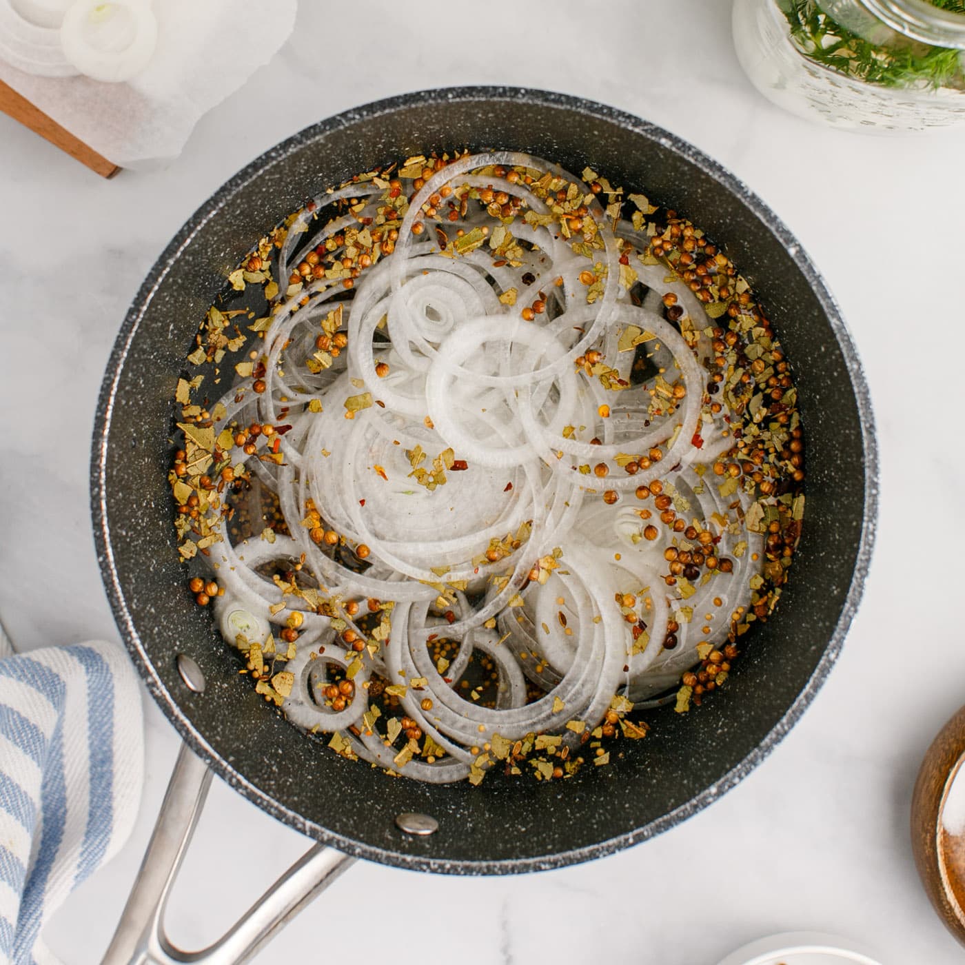 sliced onion added to saucepan with pickled eggs brine