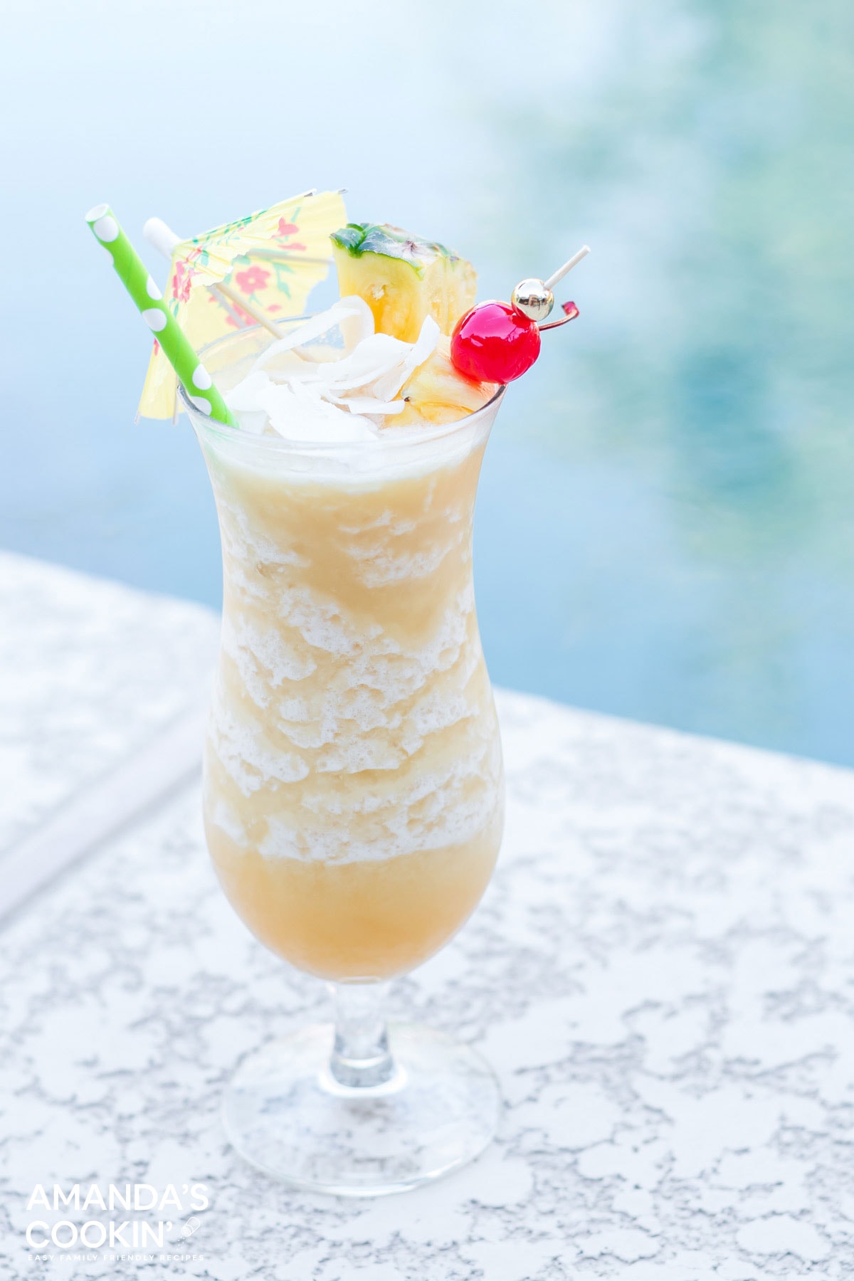 a frosty pina coloada drink sitting by the pool