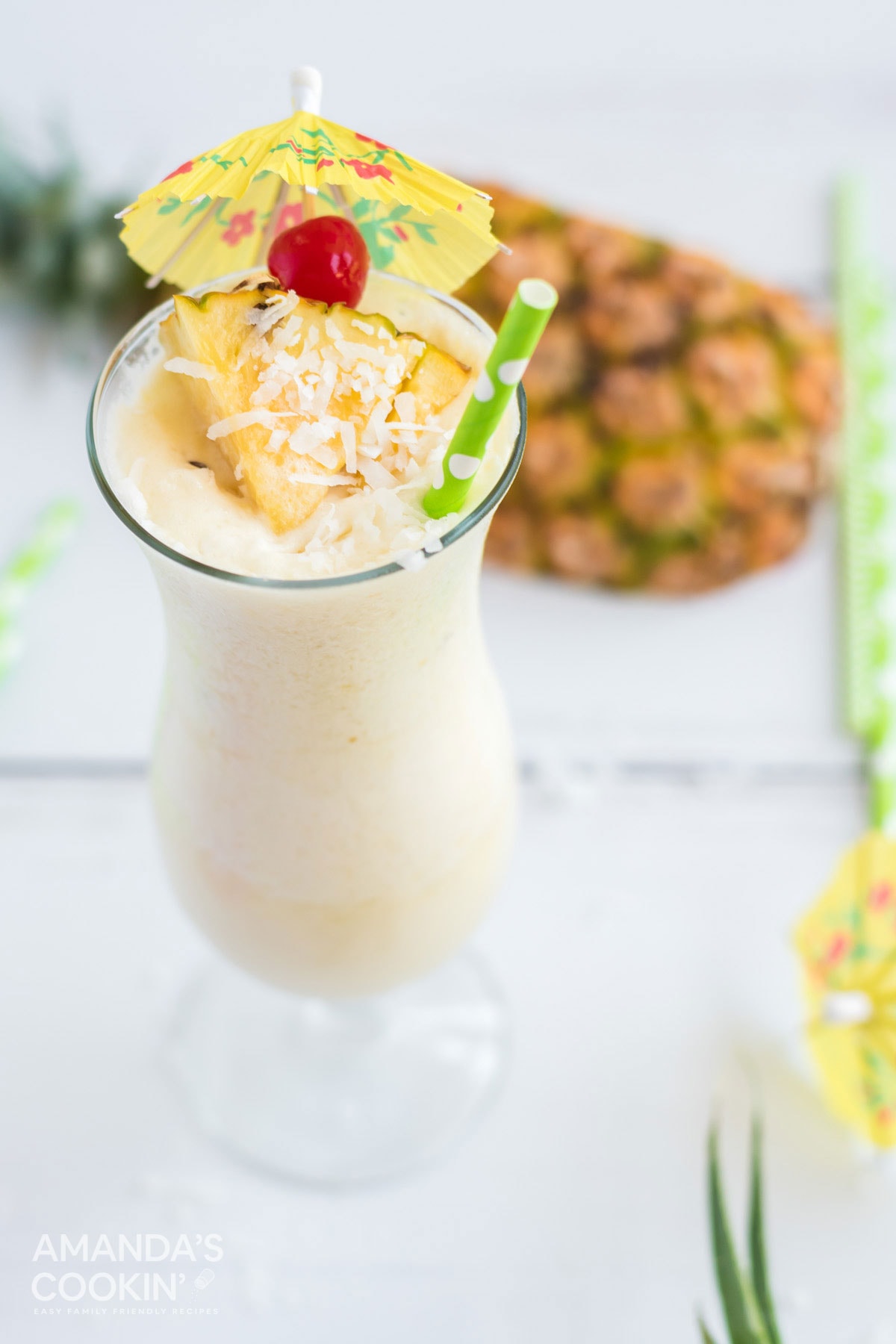 white pina colada with cherry and pineapple garnish
