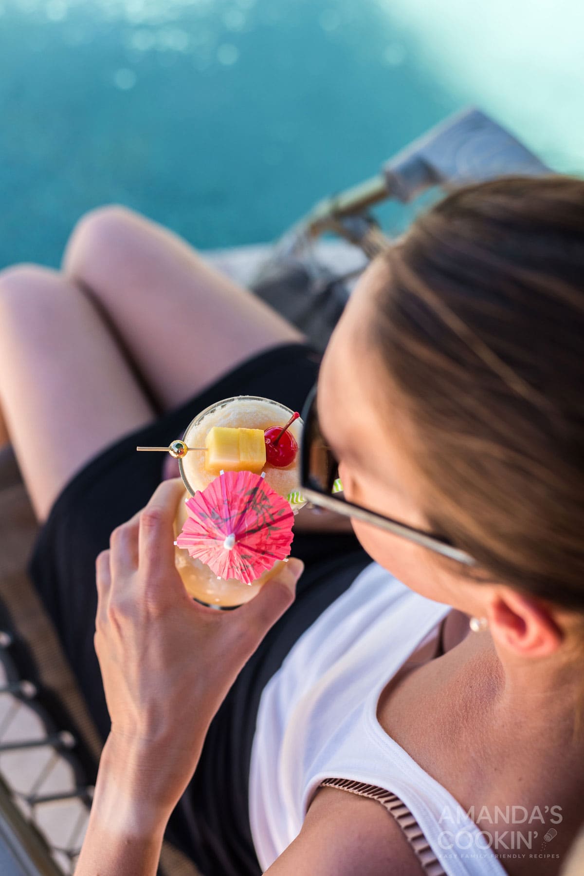 woman sipping on pina colada