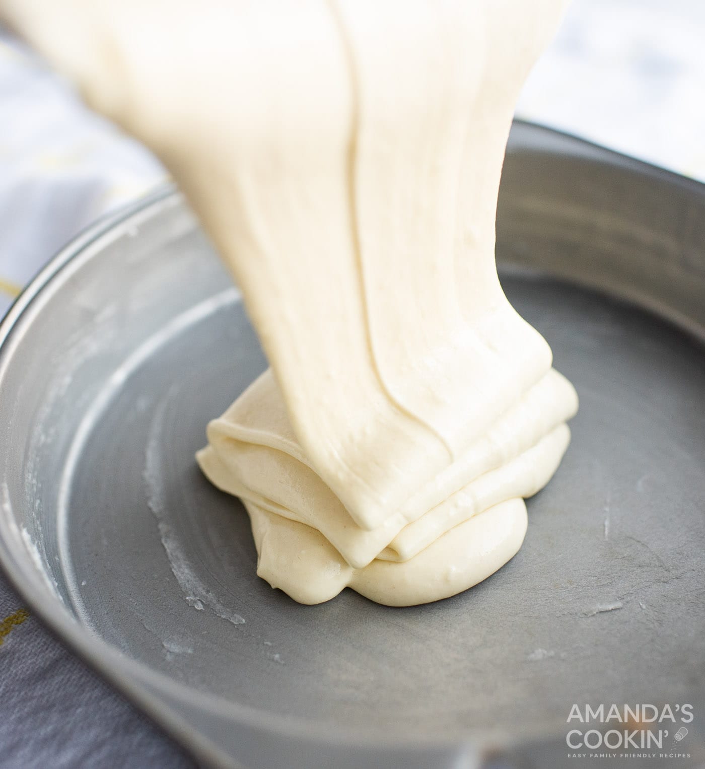 pineapple cake batter pouring into pan