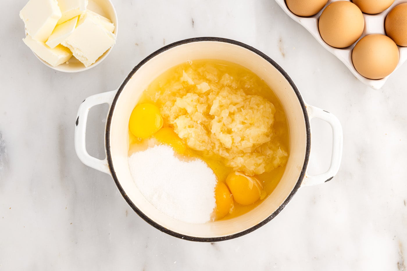 ingredients for pineapple curd in a sauce pan