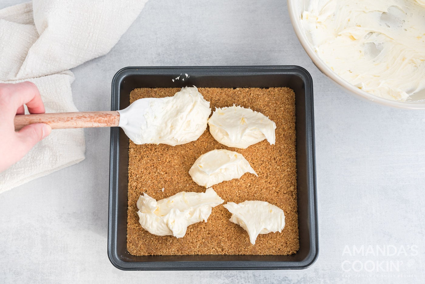 adding cream cheese mixture over crust