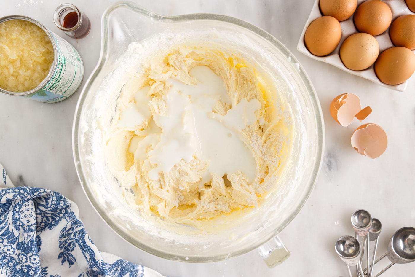 buttermilk added to pound cake ingredients in a bowl