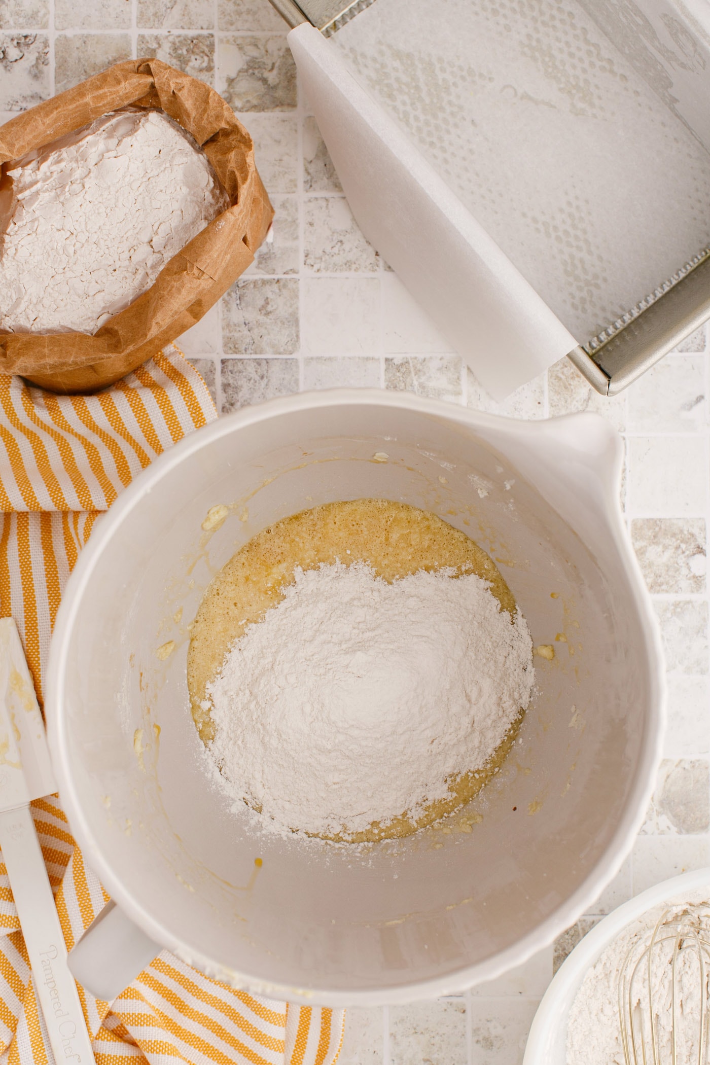 adding flour mixture to creamed butter, sugar, and eggs