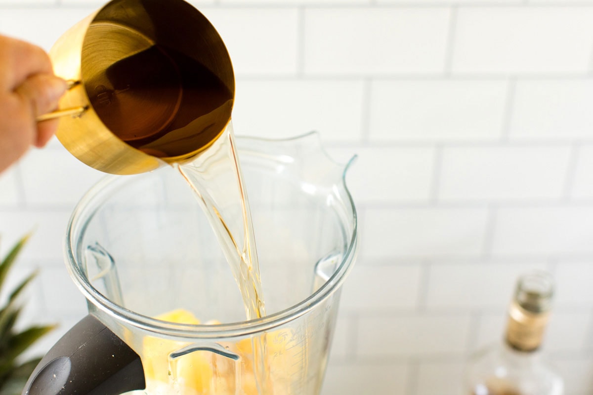 pouring run into blender