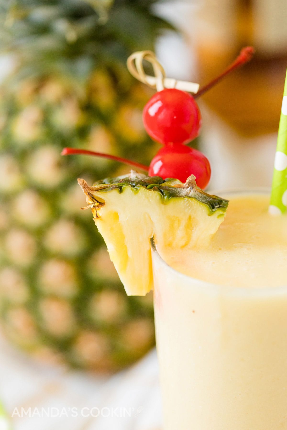 close up of cherry and pineapple garnishes on pineapple rum slush cocktail