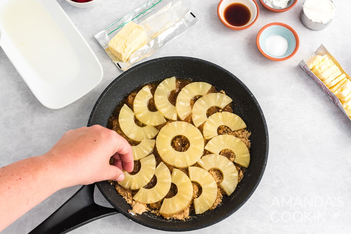 adding pineapples to pan
