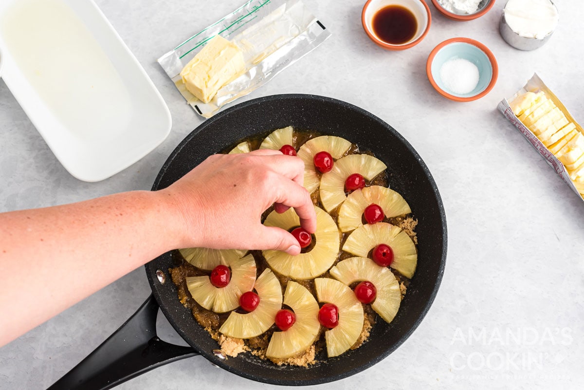 adding cherries to pan