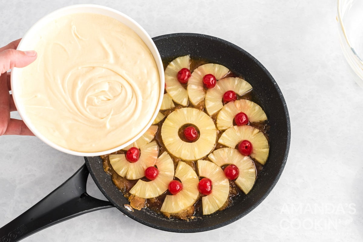adding cake batter to pan
