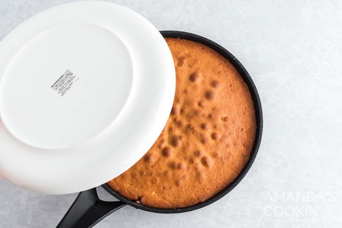 placing plate over the top of cake pan
