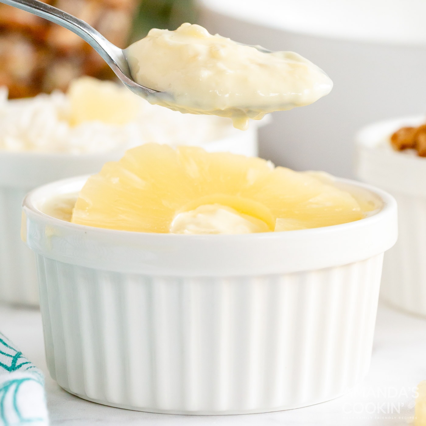 spoon lifting some pineapple yogurt dessert