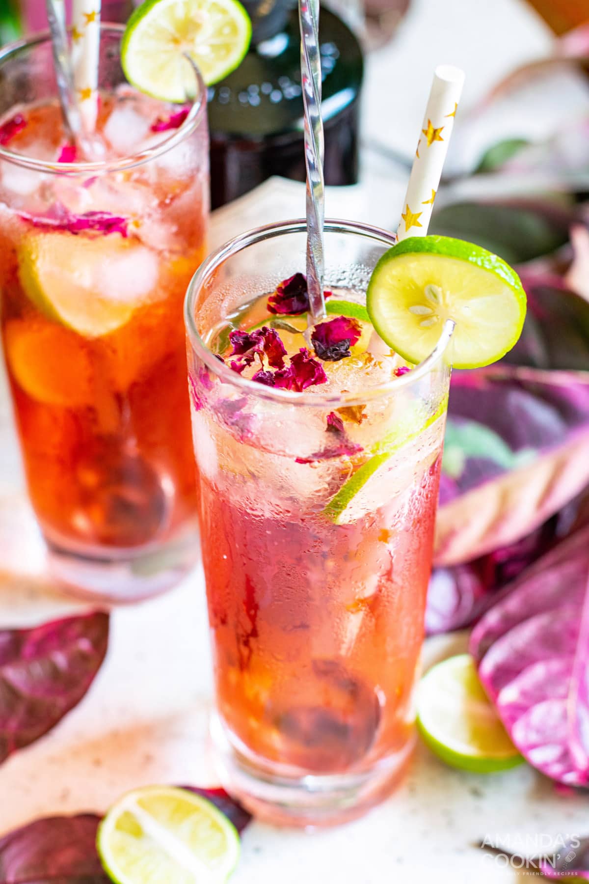 Overhead shot of Pink Gin & Tonic and lime garnish and rose petals
