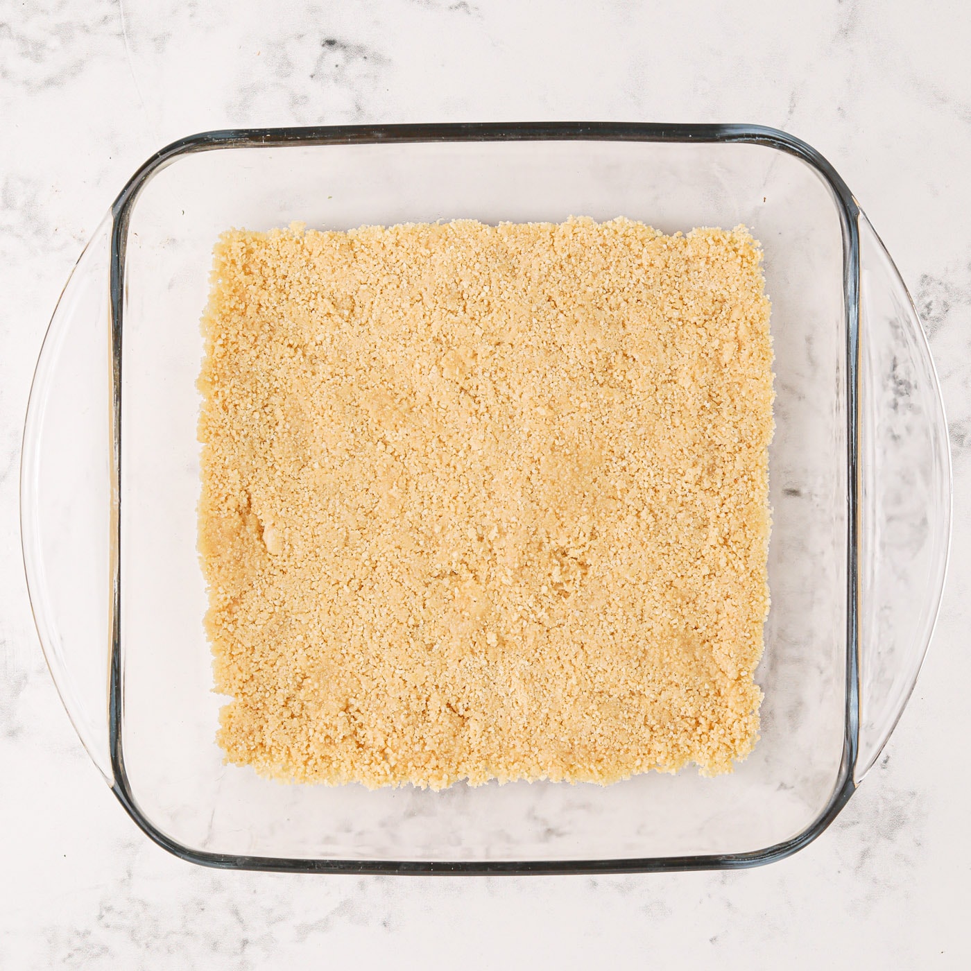 Golden Oreo cookie crust in a pan