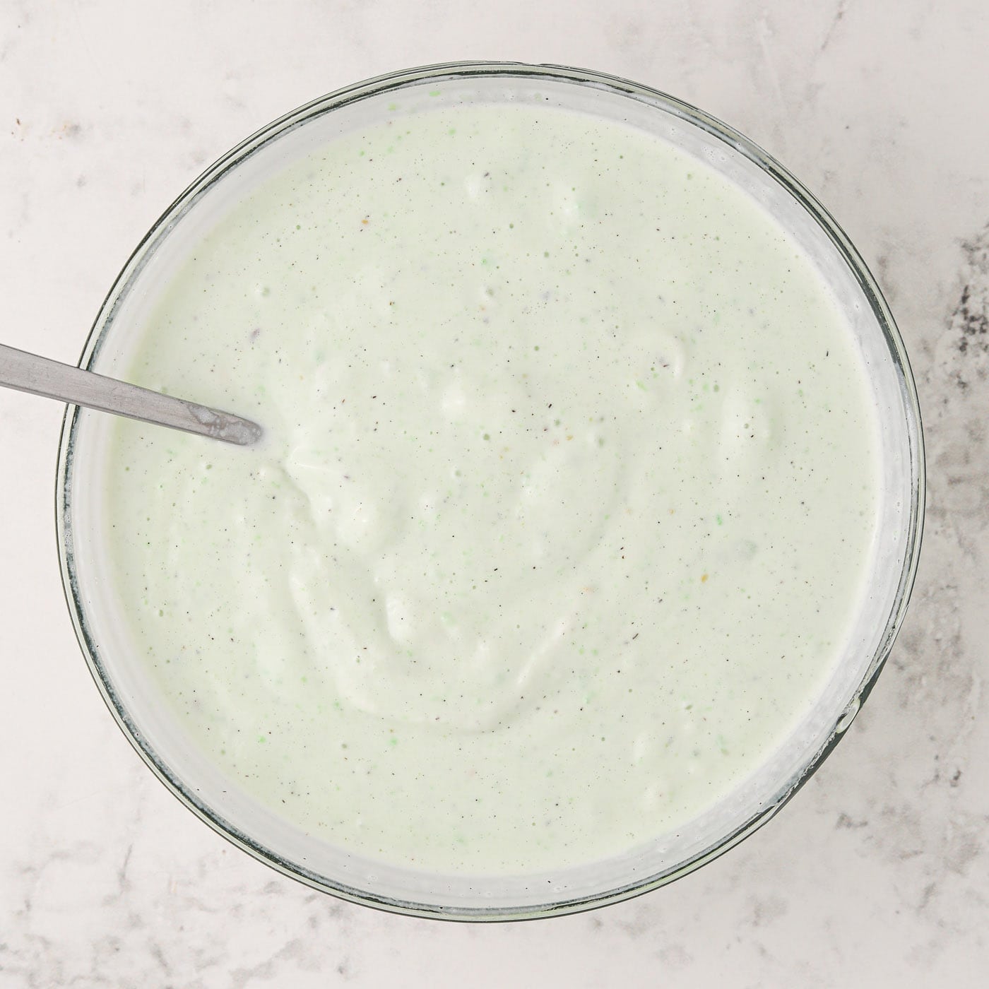 pistachio pudding mixed with vanilla ice cream in a bowl
