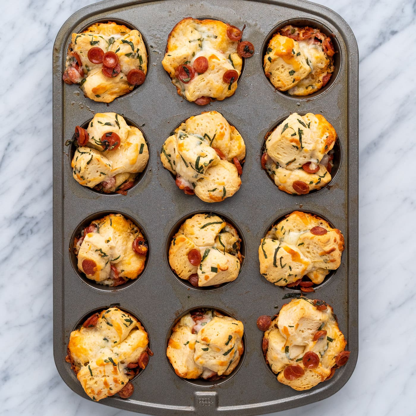 baked pizza bites in a muffin pan