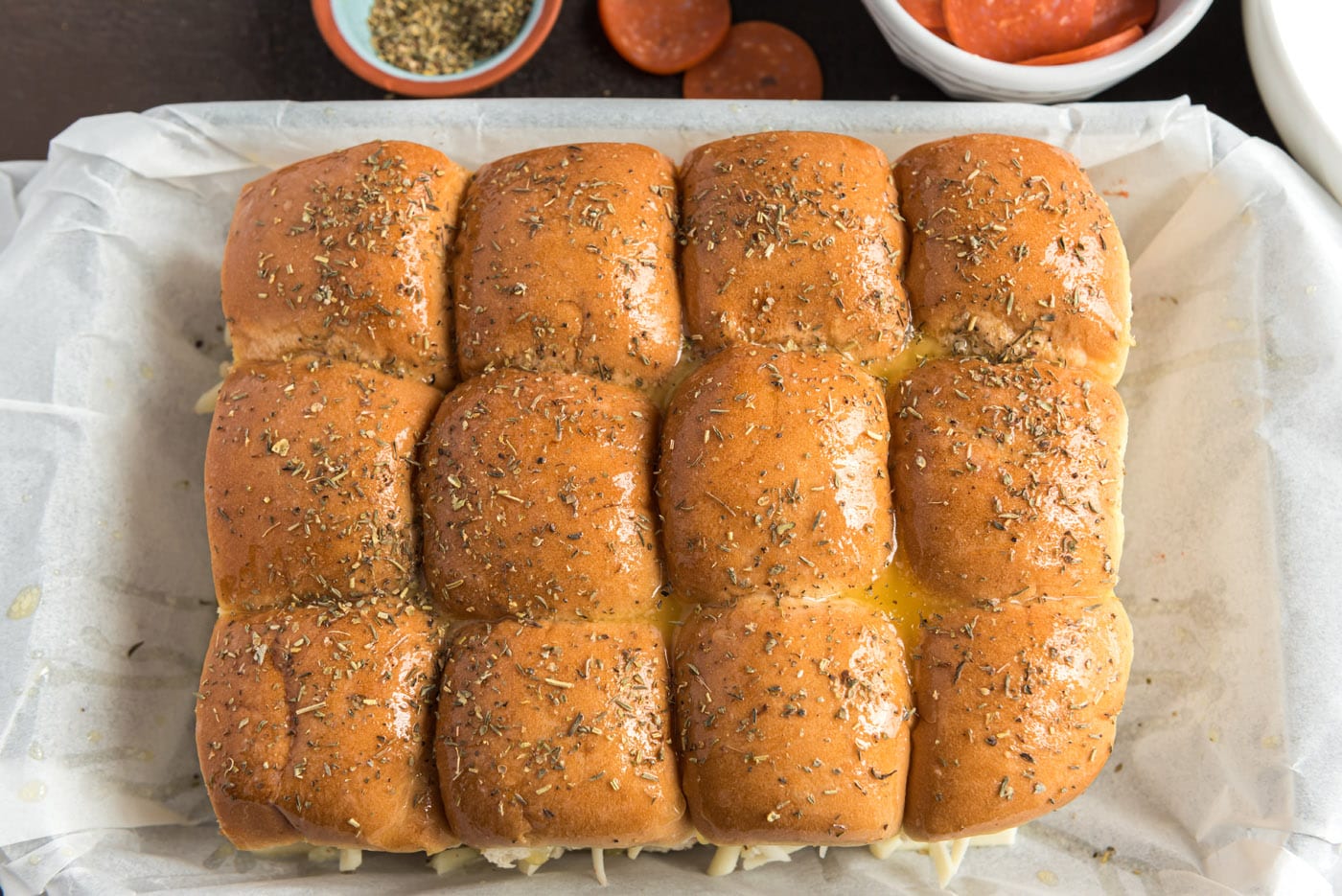Italian seasoning sprinkled over pizza sliders