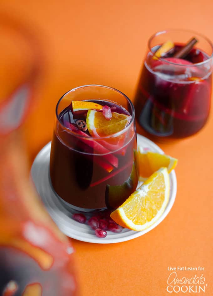 Glass of pomegranate sangria with orange slice