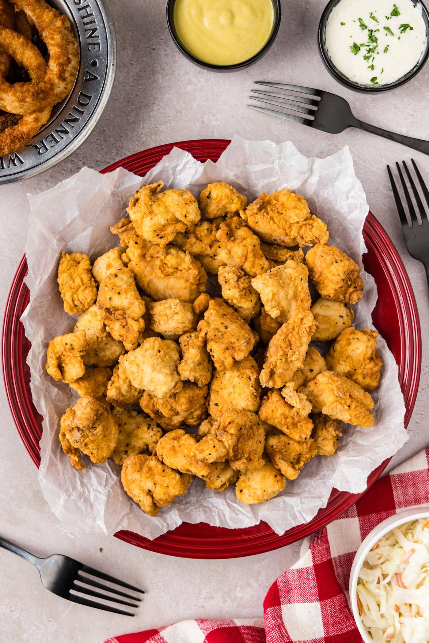 Popcorn Chicken on a parchment paper lined plate
