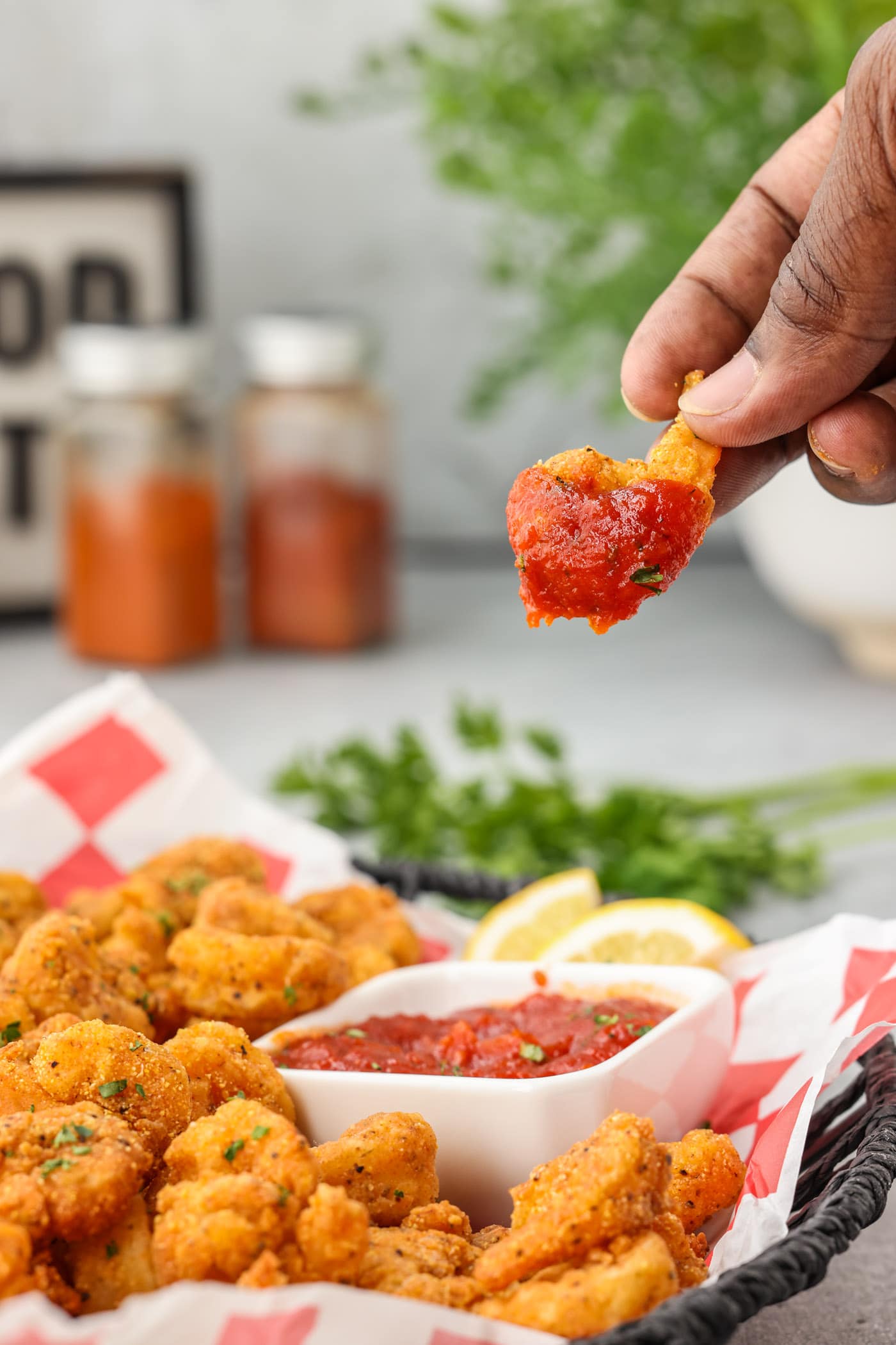 dipping a Popcorn Shrimp in cocktail sauce