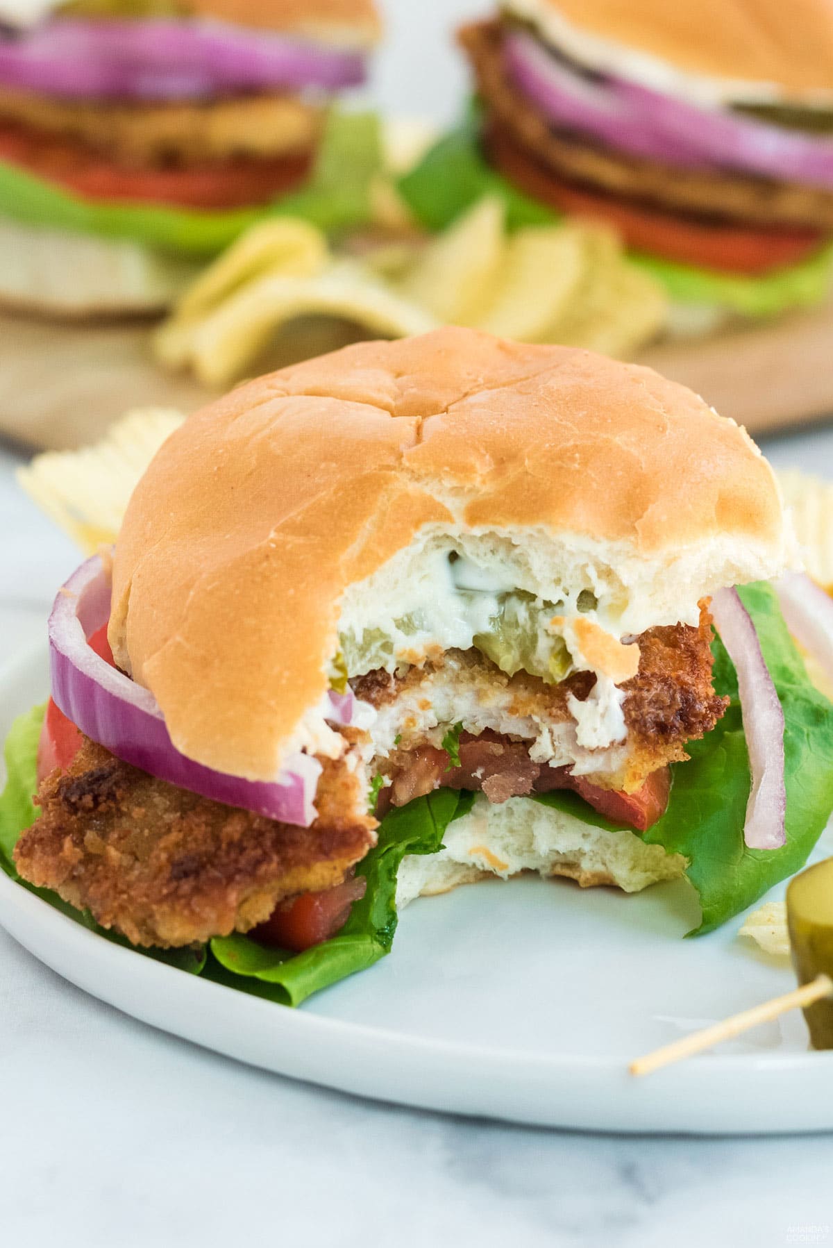 pork tenderloin sandwich with bite out of it