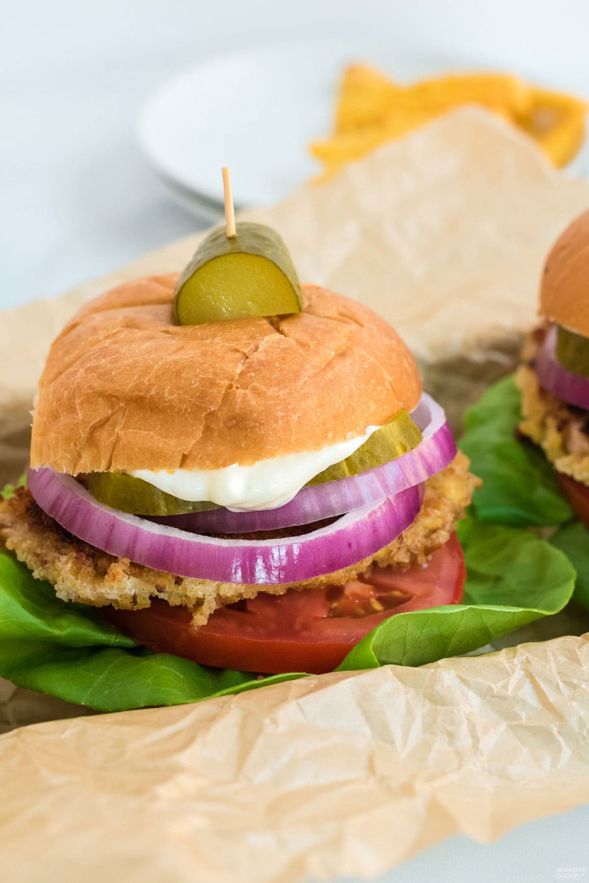 pork tenderloin sandwich with a pickle garnish