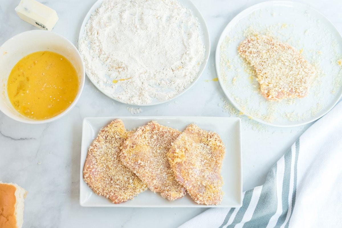 three breaded pork chops on a plate