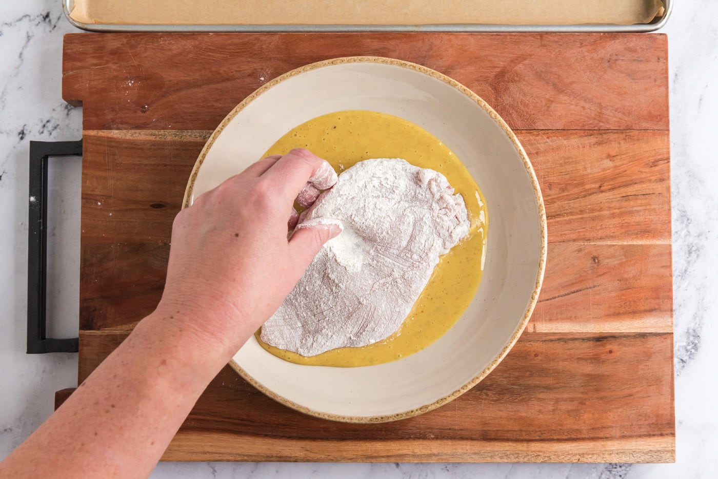 dredging chicken breast in honey mustard dressing