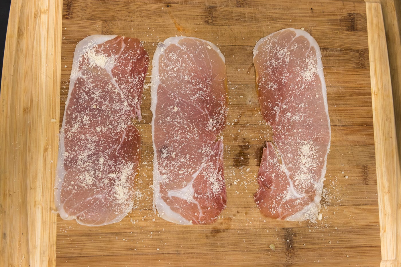 prosciutto slices with grated parmesan cheese