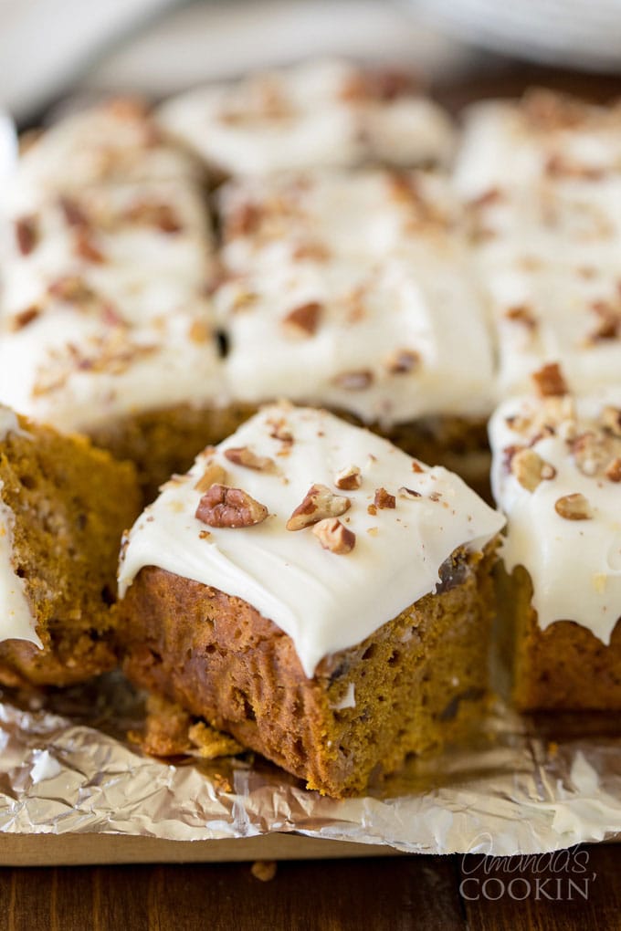 frosted pumpkin cake squares on foil