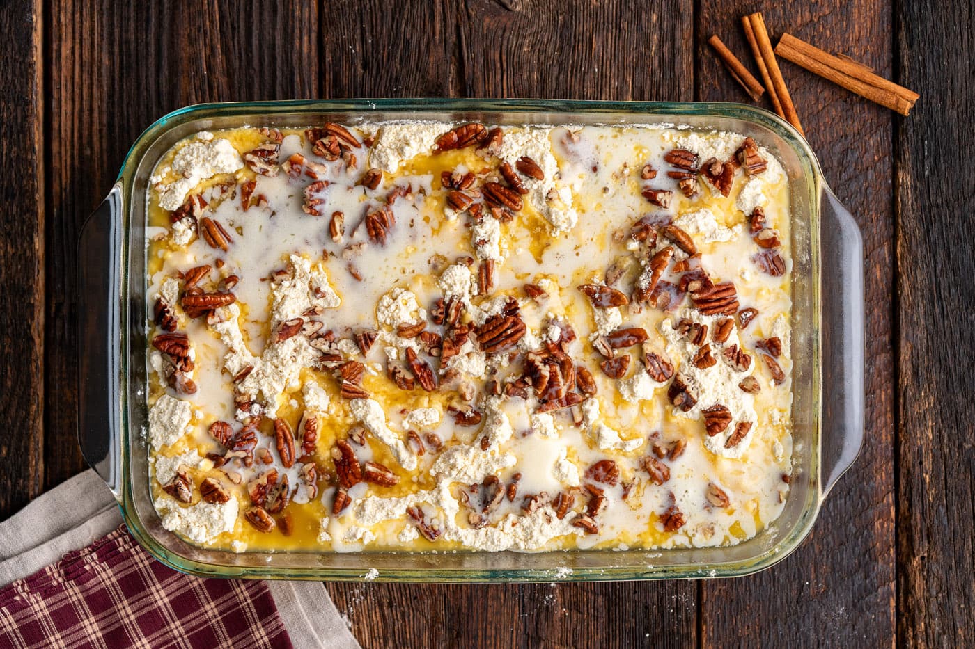 melted butter drizzled over dump cake with pecans