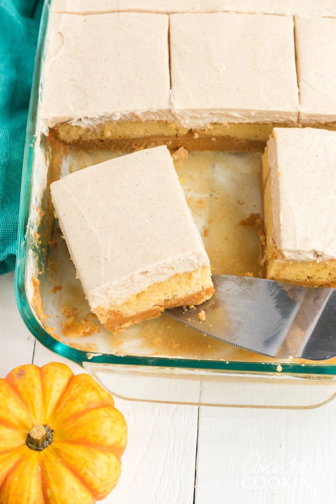 pan of pumpkin cake taking a slice out