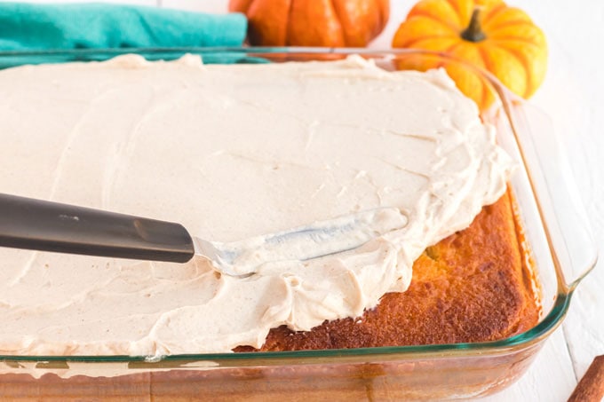 spreading icing on cake