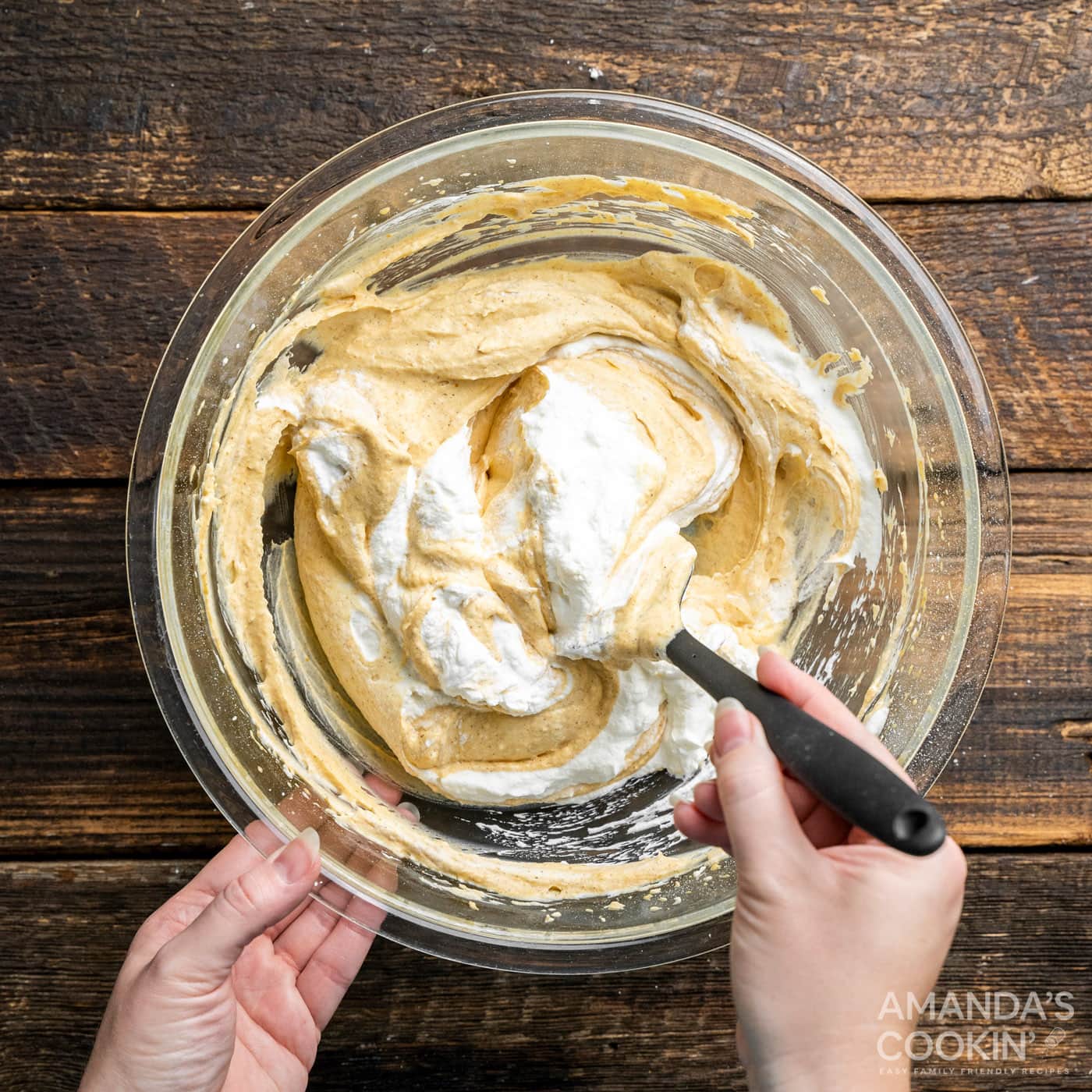 whipped cream folding into pumpkin cream cheese mixture