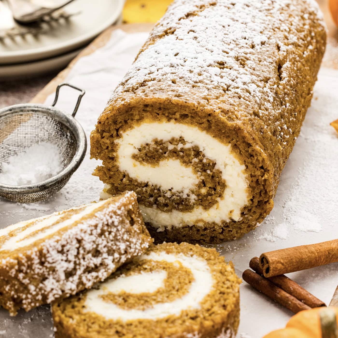 Pumpkin Cake Roll with two slices resting in front of it