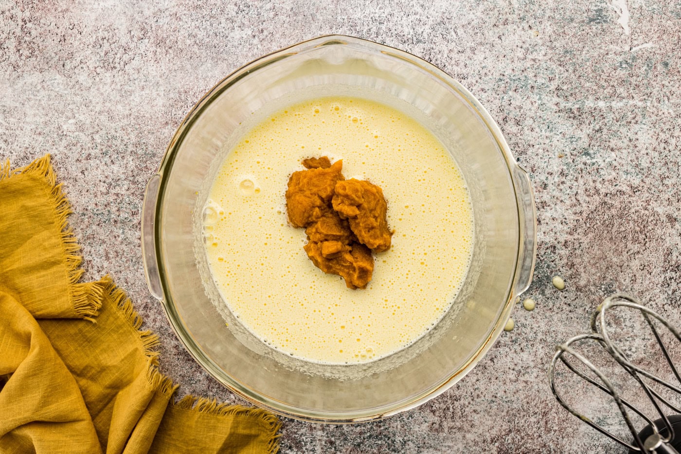 Pumpkin puree added to batter in a bowl
