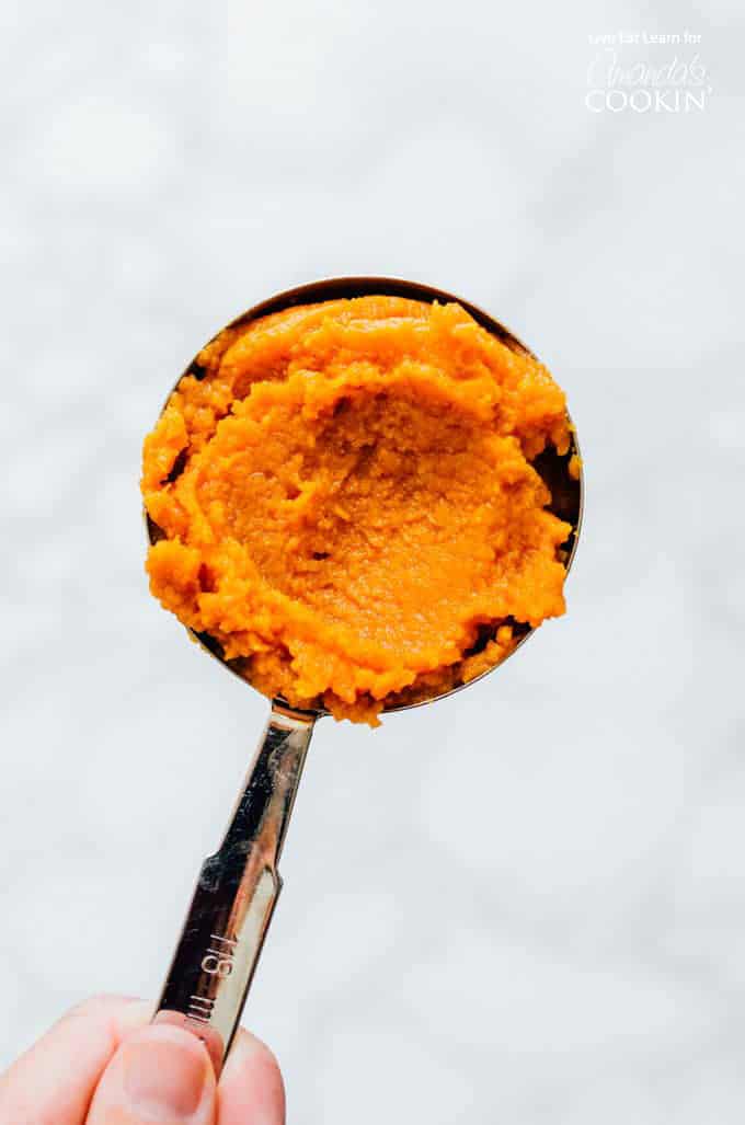Pumpkin puree in a measuring cup