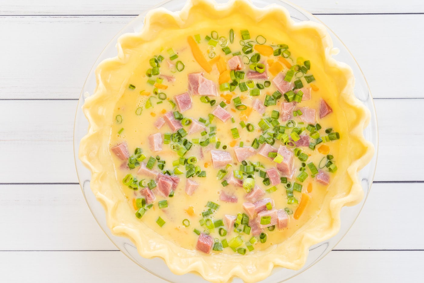 green onions on top of quiche mixture