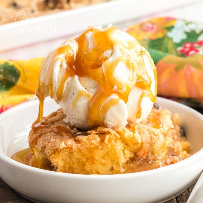 bowl of apple cranberry crisp with ice cream